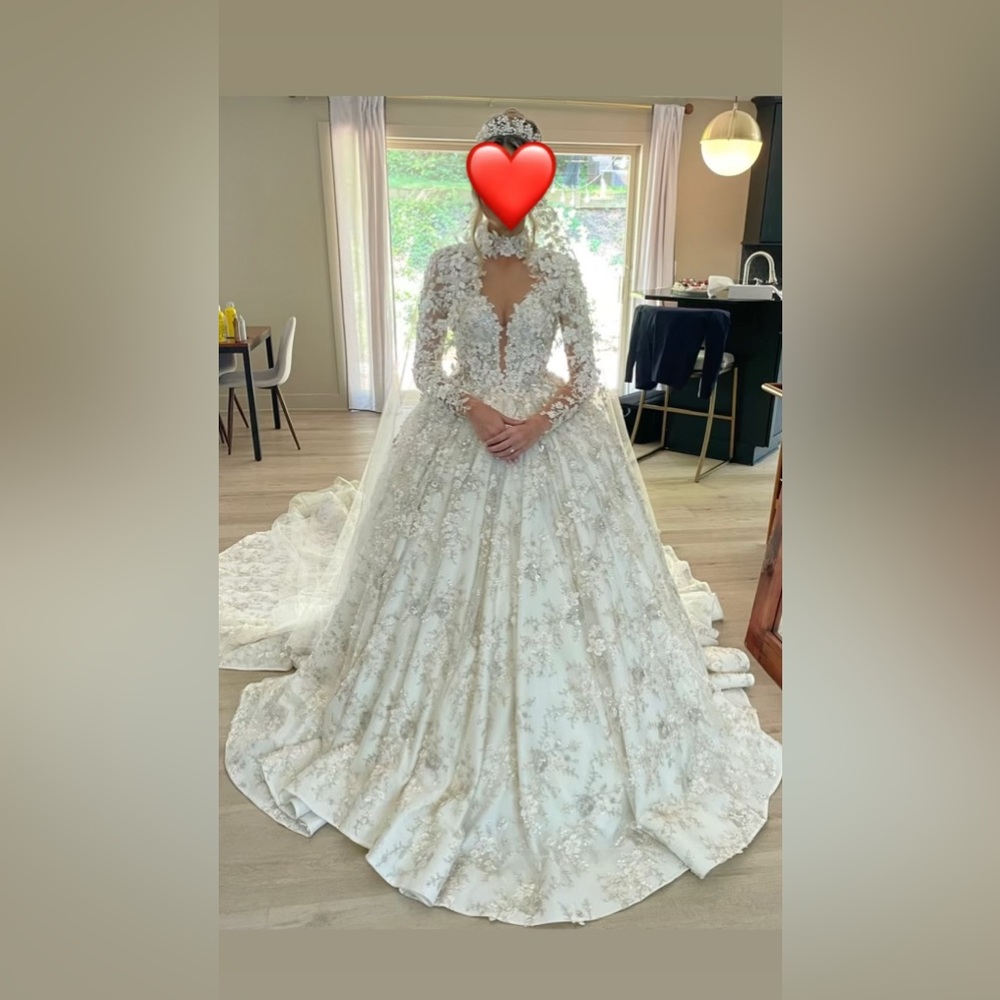 Elegant wedding dress with detailed beading. Long train. Long sleeves.